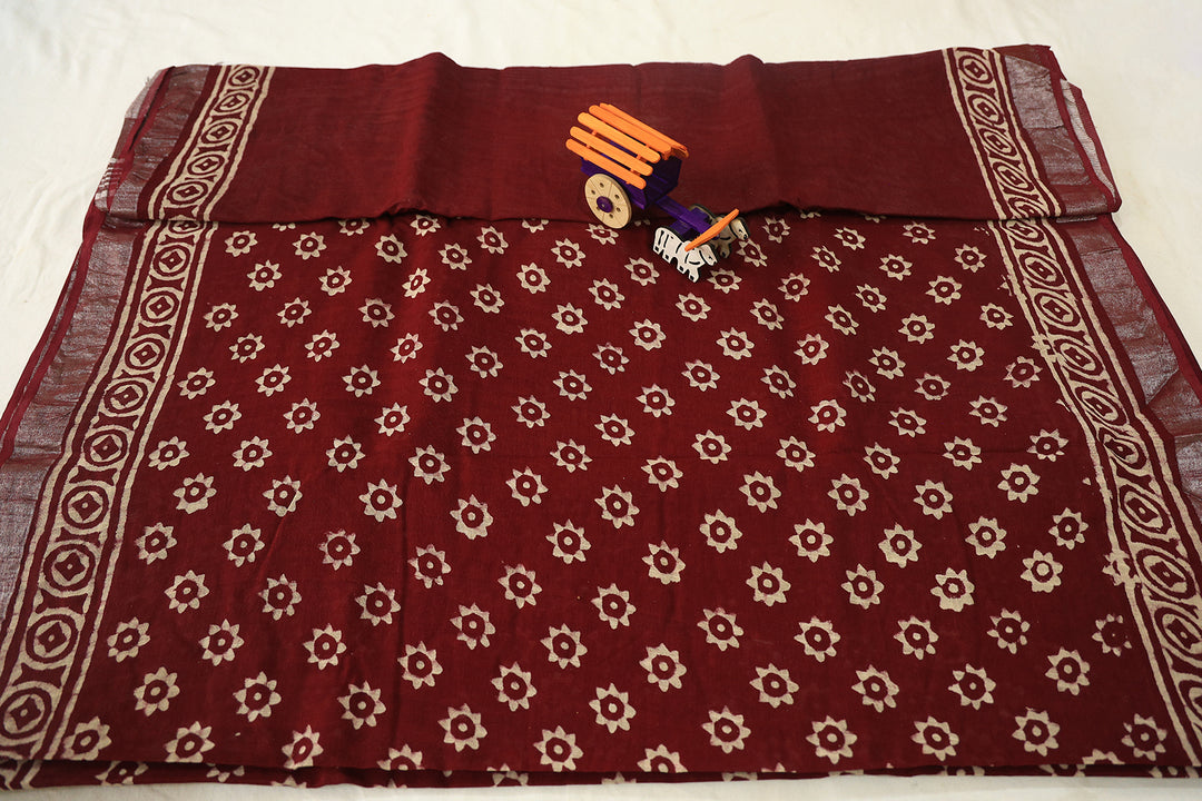 Burgundy Blossom Maroon Cotton Saree With Elegant White Florals And Silver Zari Embellishments