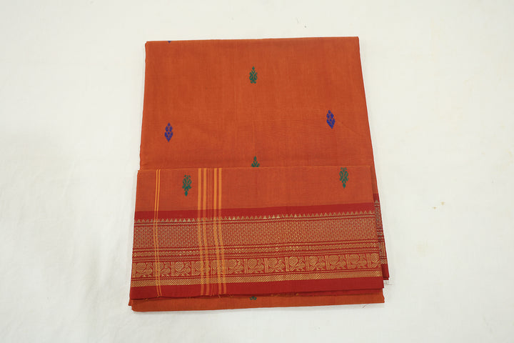 Rusty Orange Saree With Red Border, Peacock Zari Embellishments And Floral Whispers