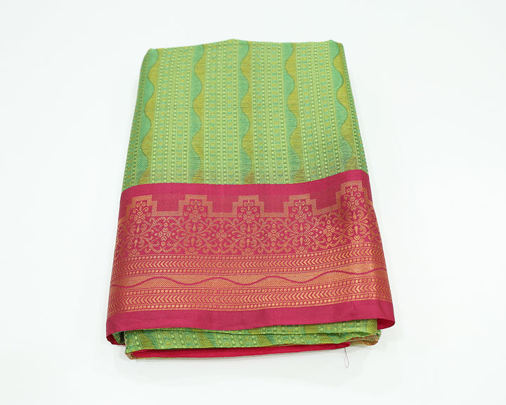 Parrot Green Dupion Silk Saree With Rani Pink Border And Gold Zari Leaf Design, Adorned With Wavy Stripe Patterns