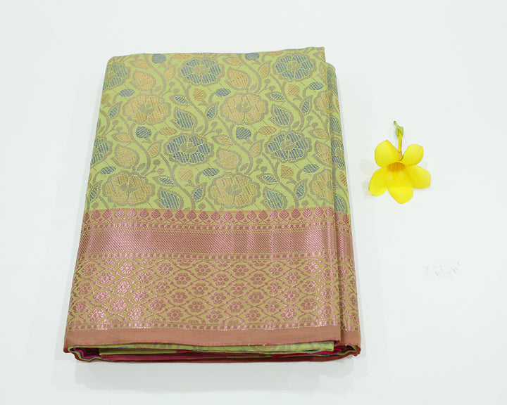 Pista Green Saree With Pink Zari Border And Pallu, Adorned With Floral Design And Patterned Blouse